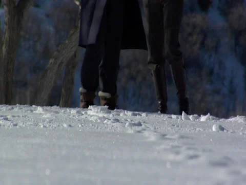 A low angle view of snow boots running on the snow land Stock Footage 23118100