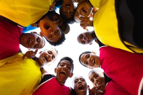 Low angle view of soccer team in circle Stock Photos