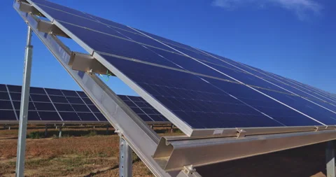 Low-angle view of solar panels generating clean renewable energy under blue sky Stock Footage 302217173