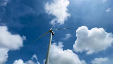 Low-angle view of a solitary windmill against a clear blue sky. Video stock 289567435