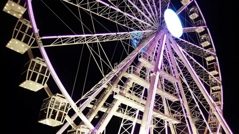 Low angle view of spinning ferris wheel at night illuminated 스톡 동영상 136951006