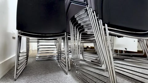 Low Angle View Of Stacked Black Office Chairs With Chrome Frames On Gray Carpet 스톡 동영상 328151295