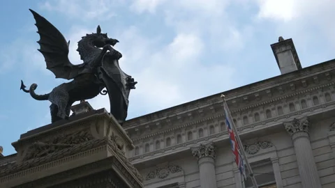 A low angle view of a statue of a dragon with a shield. Stock Footage 133466281