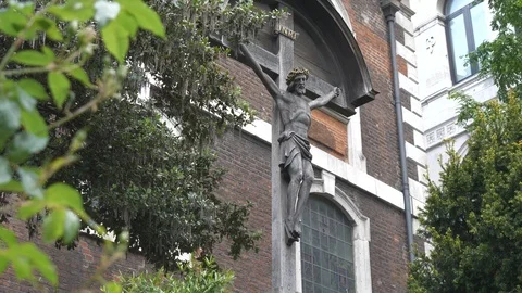 A low angle view of a statue of Jesus on a wooden cross. Stock Footage 107953876