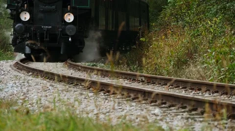 Low angle view of steam engine train crossing railroad track Stockbeeldmateriaal 43549240