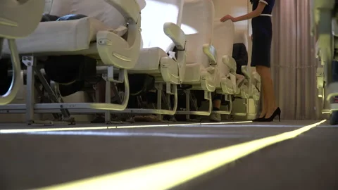 Low angle view stewardess walking the aisle to checking and serving passenger Stock Footage 147240515