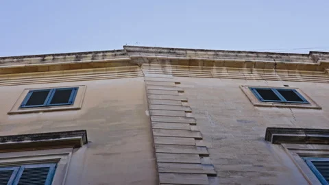 Low angle view up on a stone building, filmed in slow motion. Version 2 Stock Footage 288587307