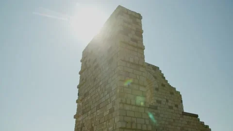 Low Angle View of Stone Wall with a Window Ruin in the Sky with the Sun Shining 스톡 동영상 166145153