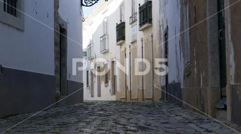Low angle view of street in Faro, Algarve, Portugal with traditional houses Stock Photos