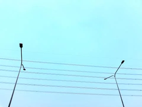 Low Angle View of Street Lighting Posts Against Clear Blue Sky Stock Photos