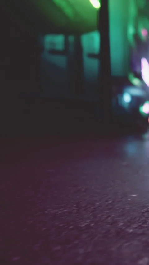 Low angle view of a street at night with colorful lights in the background Stock Footage 340883350