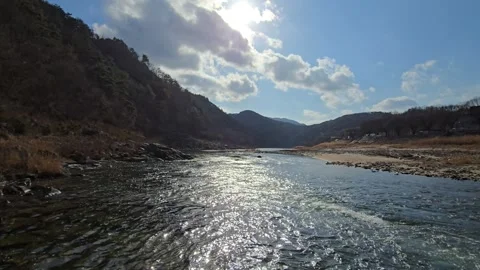 Low Angle View of Sunbeams Over Glistening River in South Korea Stock Footage 330855342