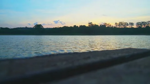 Low angle view of a sunset at Ibiúna dam from the pier Stock Footage 139060049