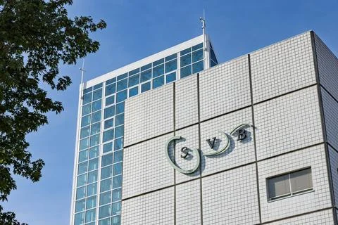 Low-angle view of the SVB office building in Amstelveen, showing the logo on Stock Photos
