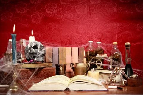 Low angle view of table full of witchcraft related objects and cobwebs Stock Photos