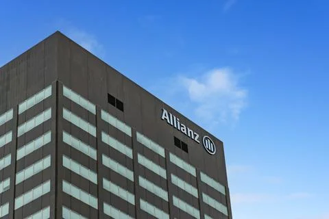 A low-angle view of a tall, featuring a dark facade with light blue windows a Foto stock