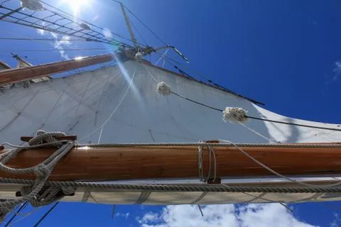 A low angle view of a tall ship sail against a bright blue sky taken looking up Foto stock