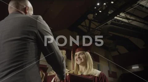 Low angle view of teacher shaking student's hand during graduation ceremony Stock Photos