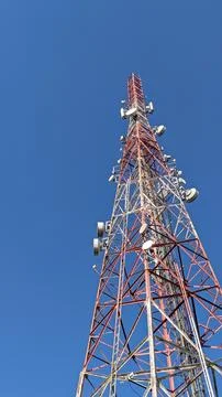 Low angle view. Telecommunication tower under clear blue sky Stock Photos