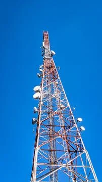 Low angle view. Telecommunication tower under clear blue sky Stock Photos