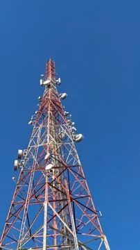 Low angle view. Telecommunication tower under clear blue sky Stock Photos