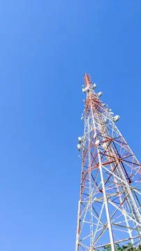 Low angle view. Telecommunication tower under clear blue sky Stock Photos