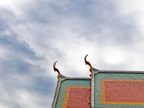 Low Angle View of Thai Buddhist Temple Rooftop Against Cloudy Sky Stock Photos