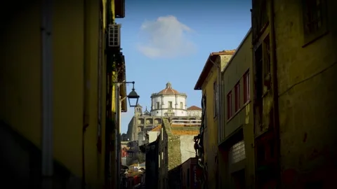 Low angle view through a Porto urban alley towards the landmark. Stock Footage 327624605