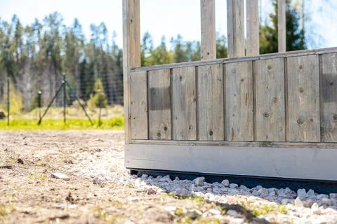 Low angle view of timber framed greenhouse base on gravel bed Stock Photos