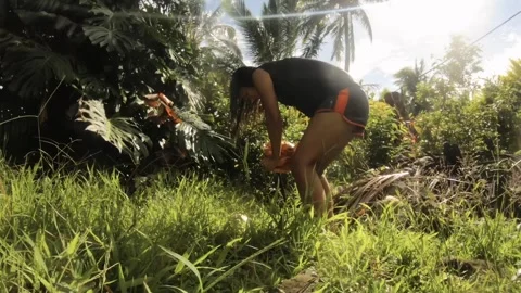 Low angle view of time-lapse of an asian tanned skin girl woman opening a coconu Stock Footage 244116096