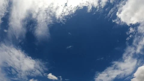 Low Angle view TimeLapse of direct bright noon sun on blue sky with clouds, s 動画素材 158416474