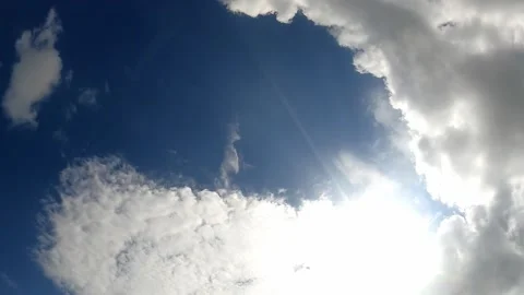 Low Angle view TimeLapse of direct bright noon sun on blue sky with clouds, s 動画素材 158416579