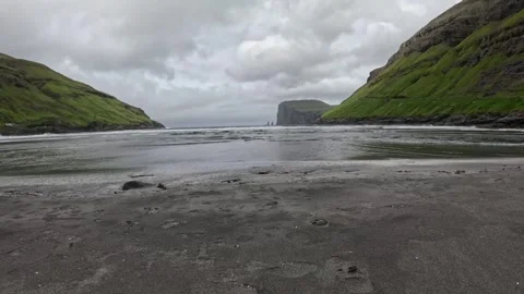 Low angle view of Tjornuvik black sand beach and sea stacks, Faroe Islands Stock Footage 339481879