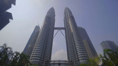 Low angle view of tourist in front of PETRONAS Towers with waterfall Stock Footage 111279908