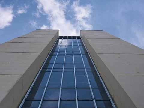 Low angle view of a tower against the cloudy sky; buildings of Bielefeld Un.. Stock-Fotos