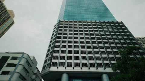 A low-angle view of towering skyscrapers with glass and steel facades in a city Video stock 303762378