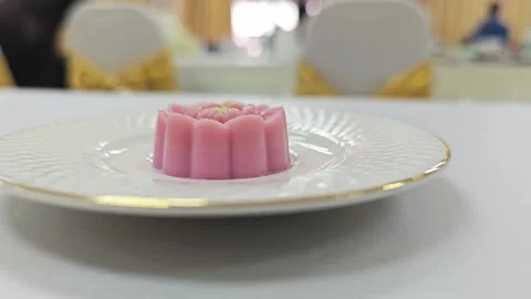 Low angle view of traditional Thai lotus flower shape dessert on a white plate. 스톡 동영상 344035550