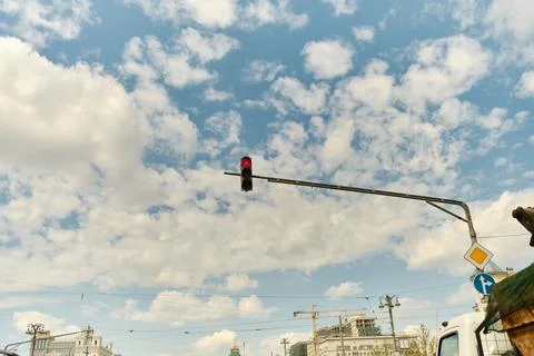 Low angle view of traffic light against blue sky with white clouds. Traffic Stock Photos