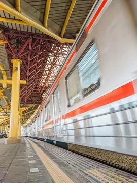 Low angle view of a train passes station platform Stock Photos
