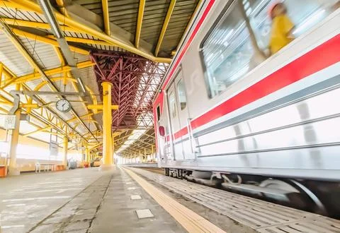 Low angle view of a train passes station platform Stock Photos