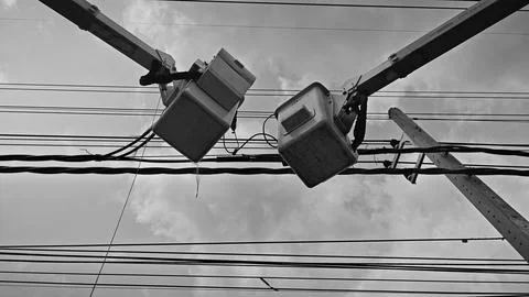 Low angle view of two aerial work platform bucket trucks repairing and join. Stock Photos