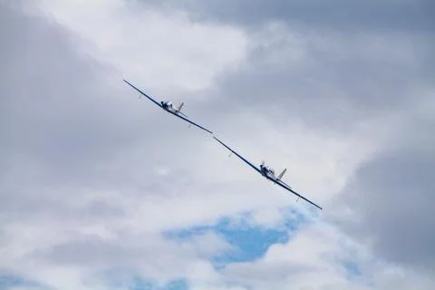 Low angle view of two aerobatic planes performing maneuvers against a cloudy  스톡 사진
