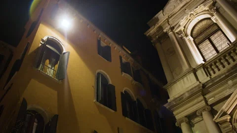 Low angle view of two classical Italian buildings at night Видео 296363300