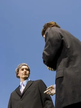 Low angle view of two mannequins portraying businessmen Foto stock