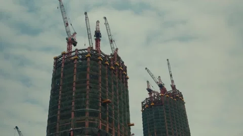 Low-Angle View of Two Massive Sk skyscrapers Under Construction with Multiple Stock Footage 337772285