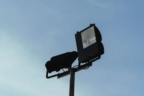 Low angle view of two street floodlights mounted on a metal pole Stock Photos