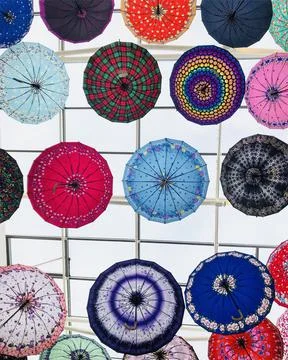 Low angle view of umbrellas hanging in city, Kuwait Foto stock