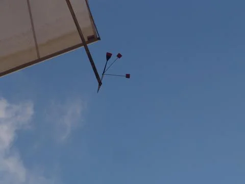 Low angle view under a cloudy sky and a light roof with a wind decoration Stock-Fotos