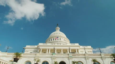 Low angle view of United States Capitol Building dome with American flag wa.. Stock Footage 334595096