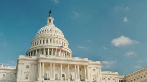 Low angle view of united states capitol building dome against bright blue sky Stock Footage 334607305